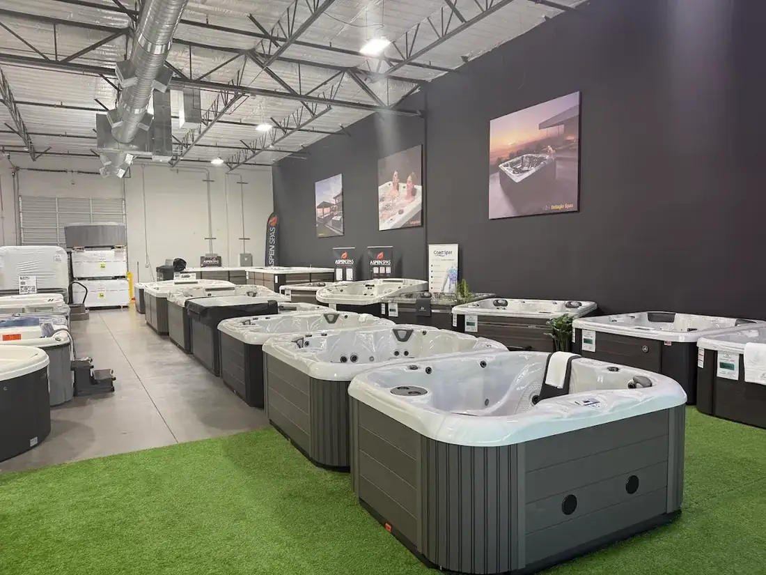 Rows of hot tubs on the showroom floor at DS Outdoor Living, including Aspen Spas and Coast Spas models