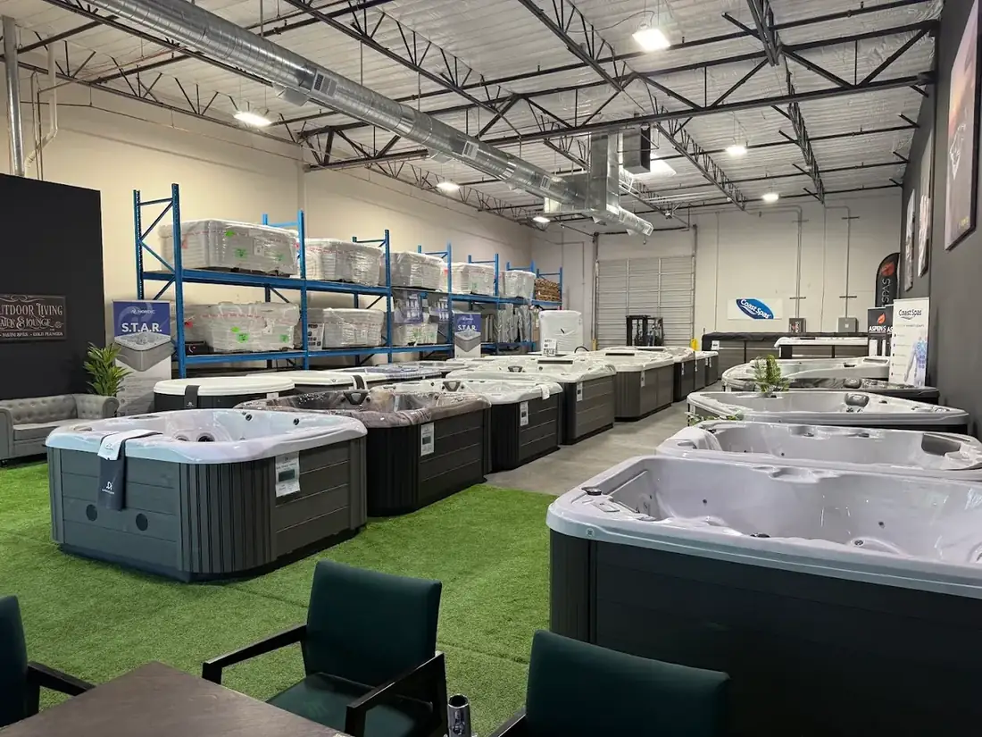 Swim spas and hot tubs displayed alongside cold plunge and sauna units in the DS Outdoor Living showroom
