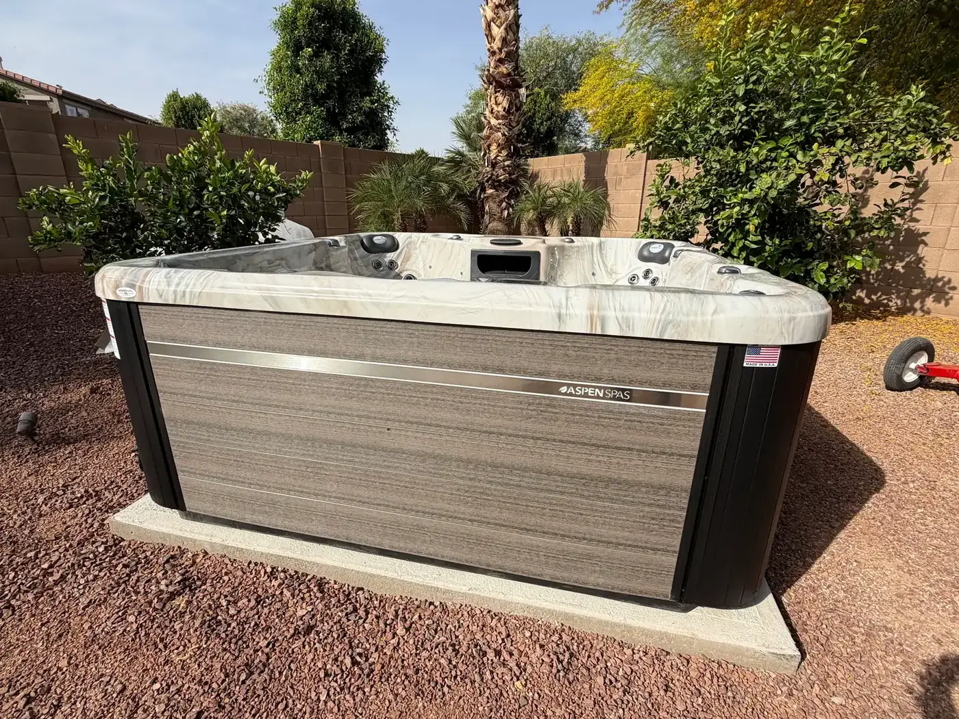 Aspen Spas hot tub installed on a concrete pad in an Arizona backyard